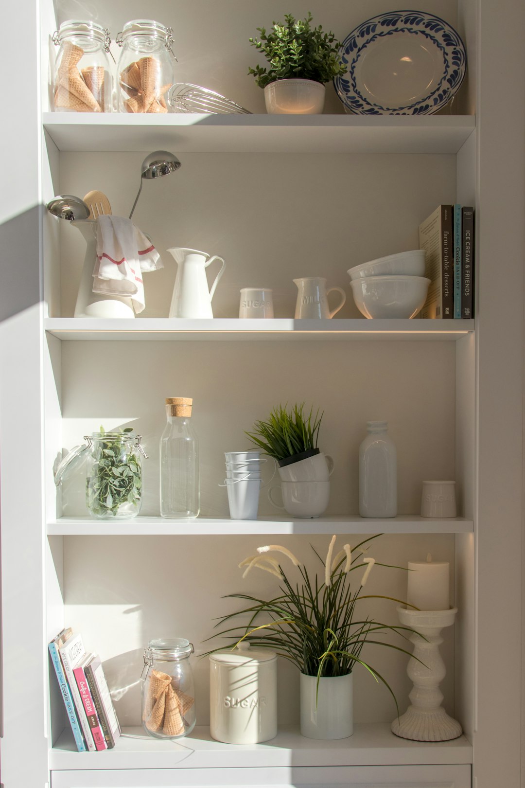 bowls-and-bottles-in-white-wooden-4-layer-shelf-frriznks13g